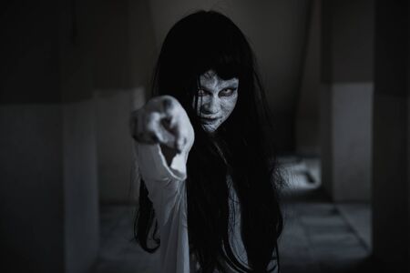 Woman ghost horror her finger point your face, halloween conceptの写真素材