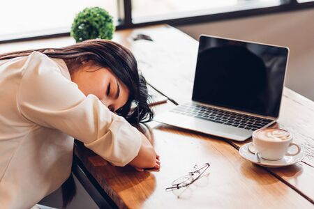 Lifestyle freelance woman he has resting sleeping after hard work long time in coffee shopの写真素材