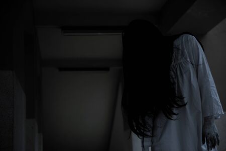 Horror woman ghost creepy standing at house, halloween day conceptの写真素材