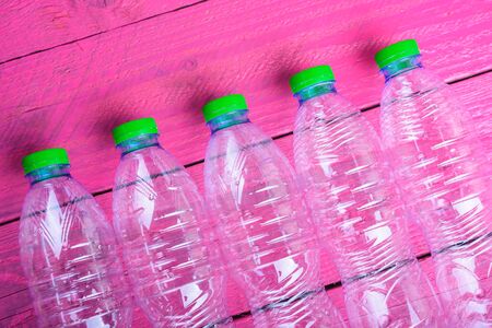 Plastic bottles garbage recycling on pink wooden, environmental conceptの写真素材
