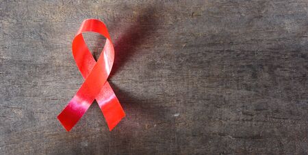 Red Ribbon Support HIV, AIDS on wooden background and copy space for useの写真素材