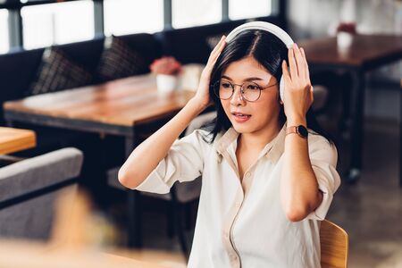 Lifestyle freelance working woman and laptop computer he listening music radio in coffee cafe shopの写真素材