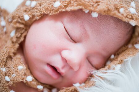 Newborn baby girl  infant sleeping on white bedの写真素材