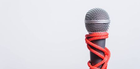 Rope on microphone with copy space on white background, Human rights day conceptの写真素材