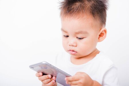 Asian portrait child boys 1 year 6 months holding smartphone on hand on white background