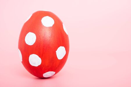 Beautiful Easter Red egg color on pink background, Easter day conceptの写真素材