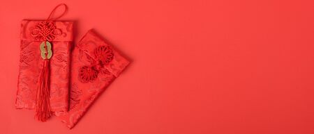 Chinese new year festival concept, flat lay top view, Happy Chinese new year with Red envelope (Character "FU" means fortune, blessing, wealth) on red background with copy space for your textの写真素材