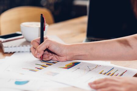 Lifestyle freelance woman and laptop computer he examined the graph profit docume in coffee shopの写真素材