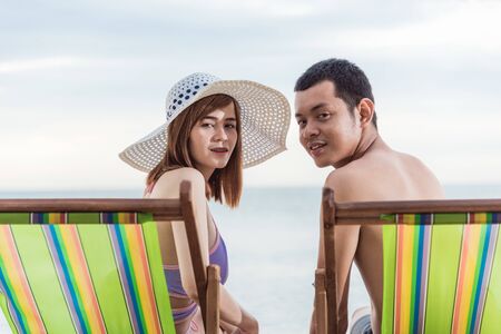 Couple luxury family travel relaxation on chair tropical beach in vacation summerの写真素材