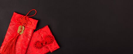 Chinese new year festival concept, flat lay top view, Happy Chinese new year with Red envelope (Character "FU" means fortune, blessing, wealth) on black background with copy space for your textの写真素材