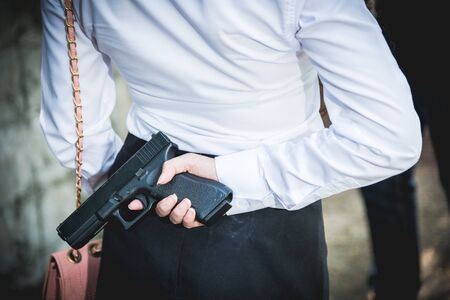 The black man robbers are about to criminal rob woman with a knife. But the woman fixes hide her gun...