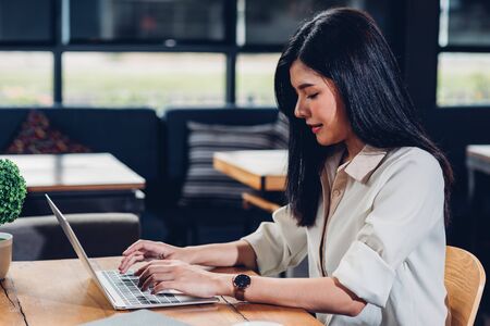 Business young women lifestyle freelance working using laptop computer in coffee shopの写真素材