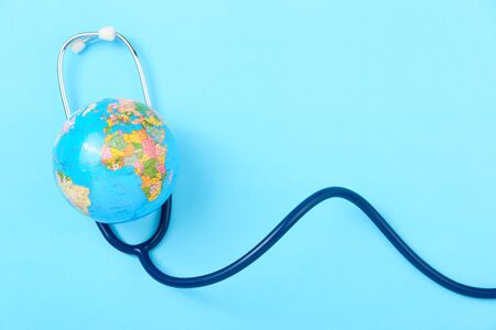 World health day concept, Stethoscope, globe on blue background with copy space. Global health careの写真素材