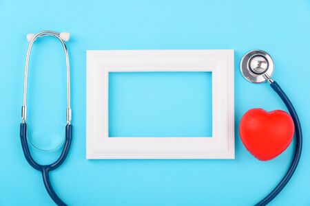 Doctor's Day concept, flat lay top view, stethoscope with photo frame diagnosis of heart disease on blue background with copy space for textの写真素材