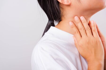 Asian beautiful woman Sore Throat or thyroid gland problem