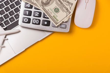 April of the year is Tax Day, Top view flat lay closeup calculator, laptop computer and Dollar money, on yellow background business finance budget concept with copy space for textの写真素材