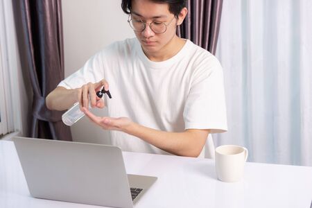 Asian business young handsome man glasses working from home office he quarantines disease...