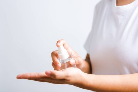 Closeup Hand Asian young woman applying spray pump dispenser sanitizer alcohol on hand wash...