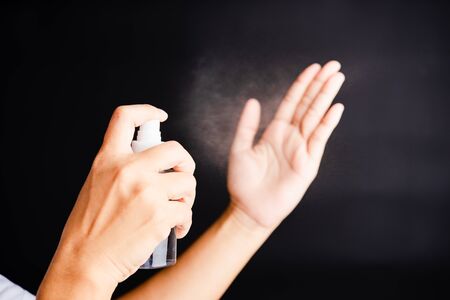 Closeup Hand Asian young woman applying spray pump dispenser sanitizer alcohol on hand wash...