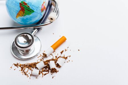 31 May of World No Tobacco Day, no smoking, close up of broken pile cigarette or tobacco and doctor stethoscope on white background with copy space, and Warning lung health conceptの写真素材