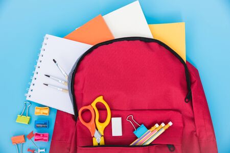 Top view Red bag backpack for education children on blue background back to school conceptの写真素材