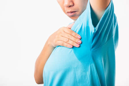 Closeup young Asian young woman hyperhidrosis sweating. Female very badly have armpit sweat stain on...