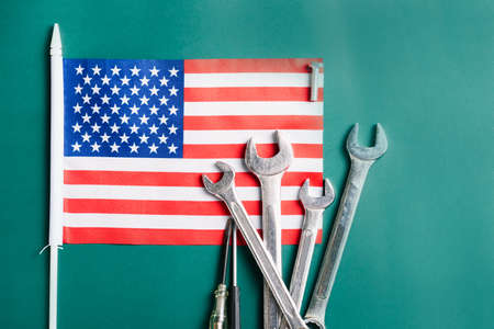 Labor day concept, Different kinds wrenches with American flag on dark green. First Monday in September, creation of labor movement and dedicated to social and economic achievements of American workerの写真素材