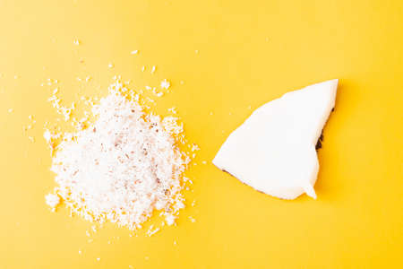 Happy coconuts day concept, fresh coconut group set different half and slices, studio shot isolated on yellow backgroundの写真素材