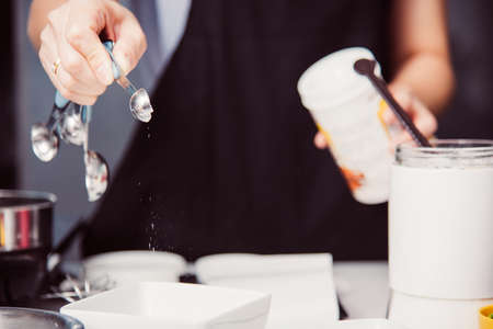 Woman during making pour measure dough before cooking bakery at homemade