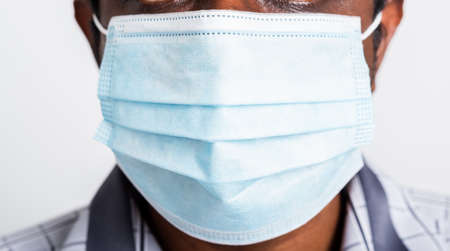 Asian happy portrait young black man wearing face mask protective from virus coronavirus epidemic or air pollution looking camera, studio shot isolated on white background, stop COVID-19 conceptの写真素材