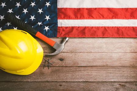 USA Labor day concept, Top view flat lay of different kinds wrenches with American flag on wood...