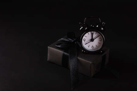 Black Friday sale shopping concept, Top view of gift box wrapped in black paper and black bow ribbon...