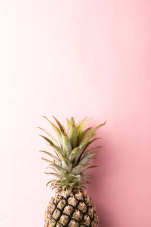 Close up above top view of ripe pineapple fruit on pink pastel background, Summer Tropical conceptの写真素材