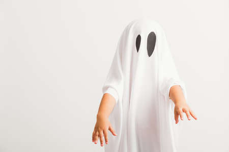 Funny Halloween Kid Concept, little cute child with white dressed costume halloween ghost scary,...