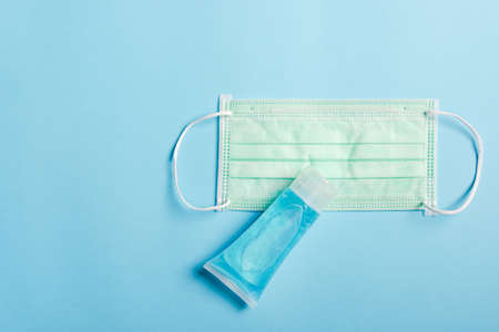 Medical protective face mask for cover mouth and nose and alcohol gel sanitizer hand gel cleaners, studio shot isolated on blue background, Safety healthcare medical prevent coronavirus or Covid-19の写真素材