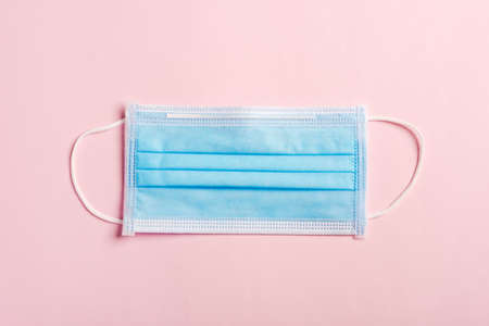 Medical blue protective face mask for cover mouth and nose, studio shot isolated on pink background, Safety healthcare medical prevent coronavirusの写真素材
