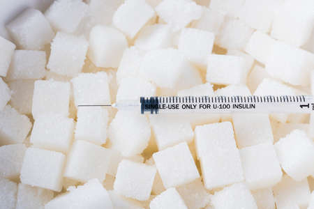 Sugar cube texture background sweet food ingredient and syringe, studio shot health high blood risk of diabetes and calorie intake conceptの写真素材