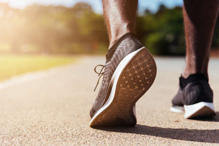 Asian young athlete sport runner black man wear feet active ready to running training at the outdoor...