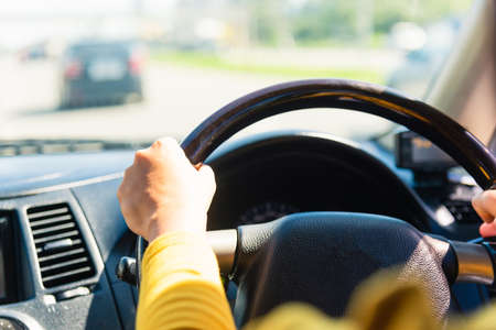Asian woman while driving the car in the morning during going to work on highway road, Transportation and vehicle conceptの写真素材
