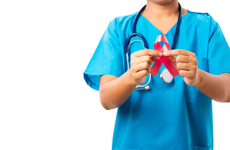Woman nurse in clinic uniform holding support HIV AIDS awareness red ribbon on hands in studio shot isolated on over white background, Healthcare and medicine, World aids day conceptの写真素材