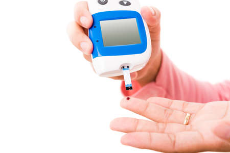Hands woman measuring glucose test level check with blood on finger by glucometer she monitor and...
