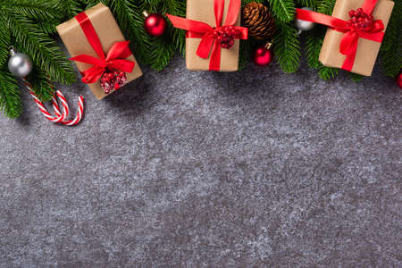 Christmas background. Top view border green pine cones fir tree branches with Xmas decoration and...