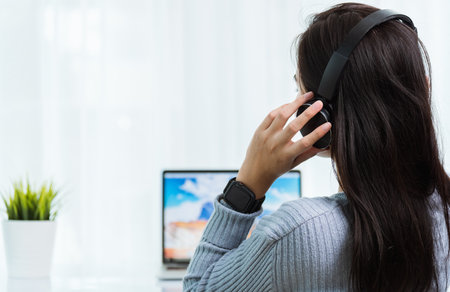Work from home, Asian young business woman feeling relaxing listening to music with headphones on...