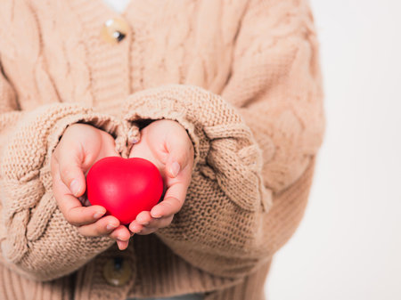 Love Valentine's Day. Woman beauty hands holding red heart for giving help donation medical healthcare concept isolated on white background, holiday background conceptの写真素材