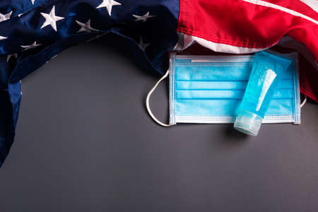 Medical protective disposable face mask for cover mouth and America flag, studio shot on gray backgroundの写真素材