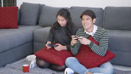 Happy Asian beautiful young family couple husband and wife smile and laugh enjoying funny with each...