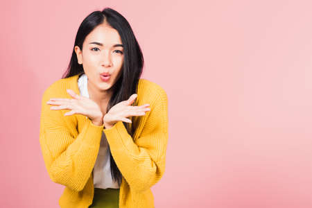 Asian happy portrait beautiful cute young woman teen standing blowing kiss air something on palm...
