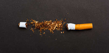 31 May of World No Tobacco Day, no smoking, close up of broken pile cigarette or tobacco STOP symbolic on black background with copy space, and Warning lung health conceptの写真素材