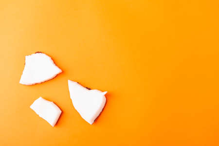 Happy coconuts day concept, fresh coconut group pieces slices, studio shot isolated on orange backgroundの写真素材