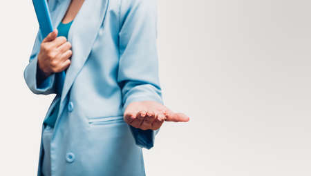 Young business woman holding file document and one hand showing present isolate on white backgroundの写真素材